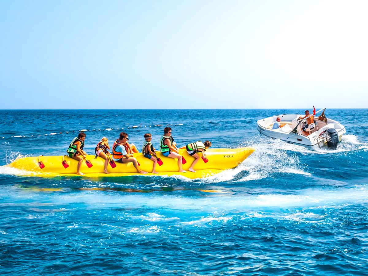Gruppo di amici sulla banana trainata dalla barca